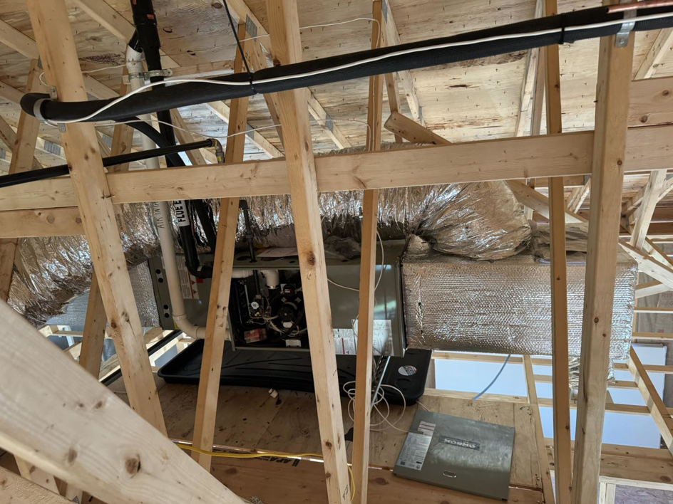 An HVAC furnace and ductwork installation in a residential attic by Ferreira Mechanical, LLC in Fall River, MA