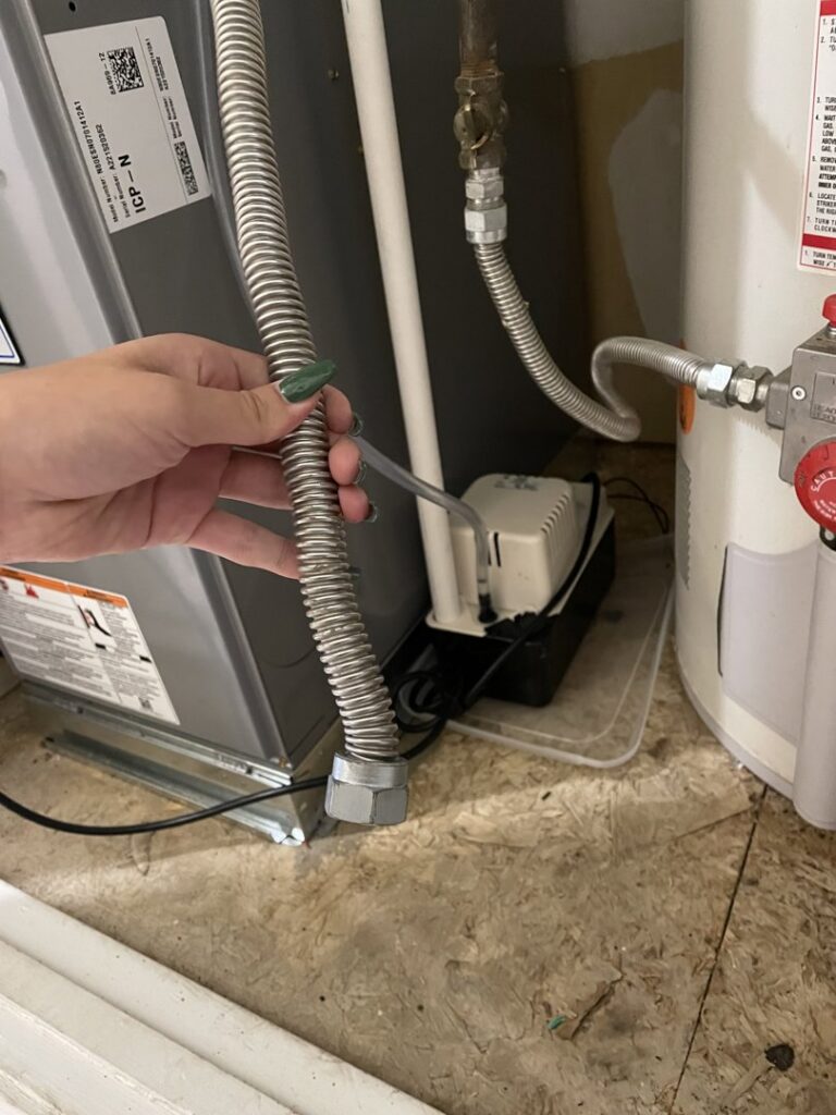 A flexible gas line connected to an HVAC furnace unit by NM Heating and Air in Albuquerque, NM.