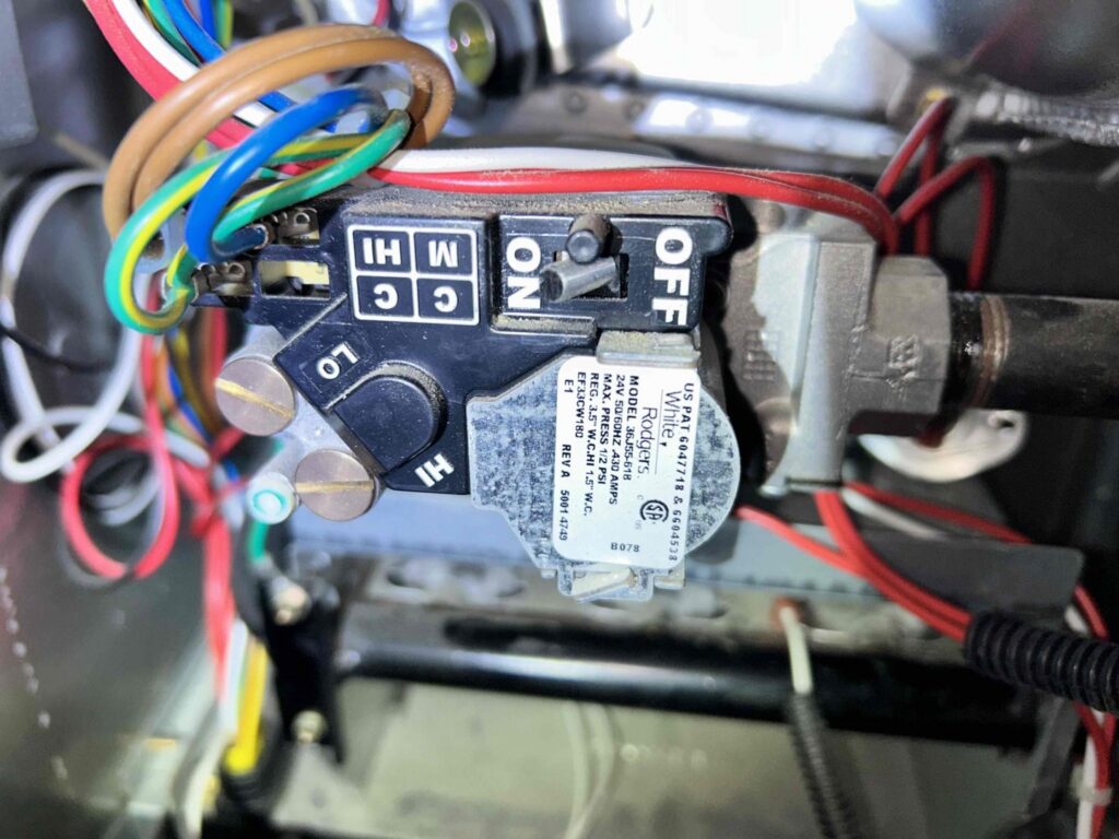 A close-up view of an HVAC furnace gas valve and wiring by Residential Express Heating & Air in Sterling, VA.