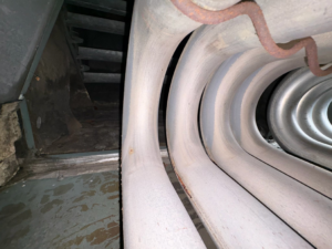 A close-up view of a furnace heat exchanger during an inspection by Roy Rogers Heating and Air in Indianapolis, IN.