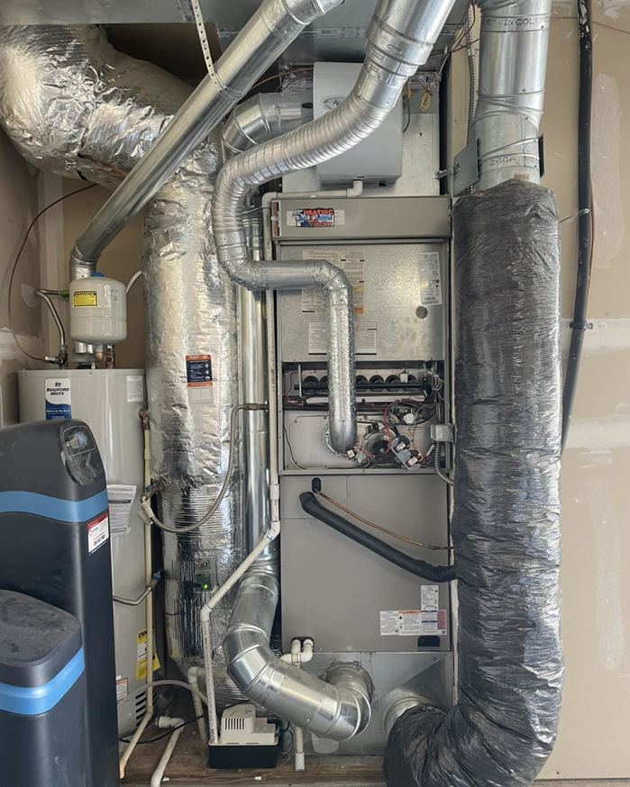 A complete HVAC furnace system installation with ductwork, water heater, and softener by AC Heating & Cooling in Meridian, ID.