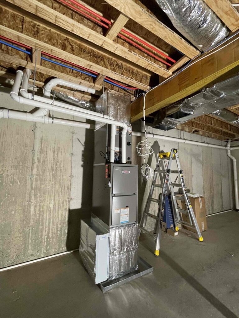 A new HVAC furnace and ductwork installation in a basement by Unified Home Solutions in Stamford, CT.