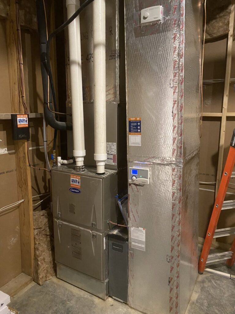 An indoor HVAC furnace and air handler unit with new ductwork installed by Chad Byers - Edge Guys Heating & Cooling in Carmel, IN