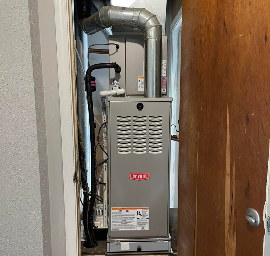 A Bryant HVAC furnace unit professionally installed in a utility closet by Bowmans Heating and Air LLC in Middletown, KY