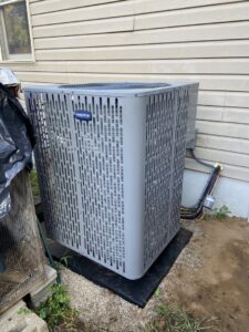An indoor HVAC furnace installation with ductwork and piping by F & S Williams in Lafayette, IN.