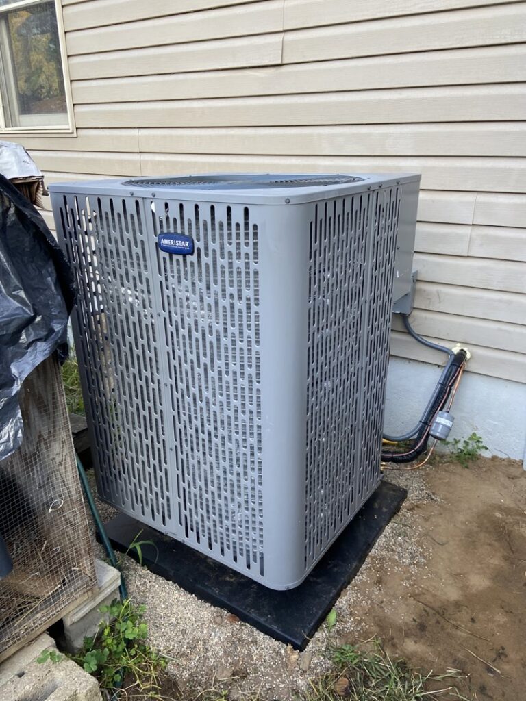An indoor HVAC furnace installation with ductwork and piping by F & S Williams in Lafayette, IN.