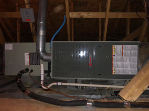 An indoor HVAC furnace and air handler unit installed in an attic by Fred's Heating And Cooling in Charlotte, NC