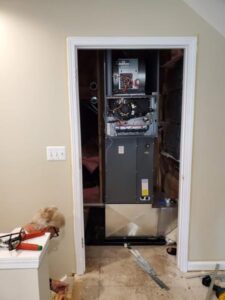 An HVAC furnace unit being installed in a utility closet by Perfect Comfort Systems in San Bernardino, CA