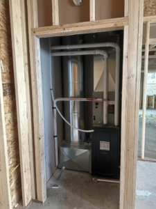 New HVAC furnace and ductwork installation in a framed closet during construction by ALC Universal in Sheridan, WY.