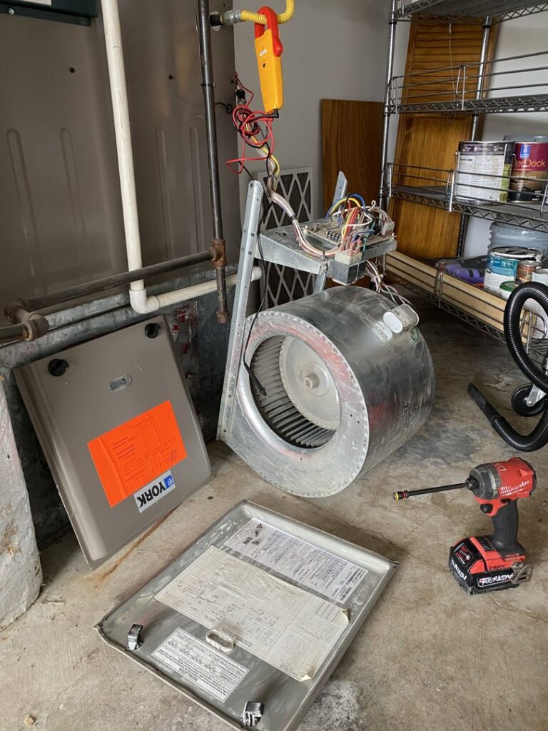 Disassembled furnace components and tools during an HVAC repair by Heatwave Heating & Air LLC in Federal Way, WA.
