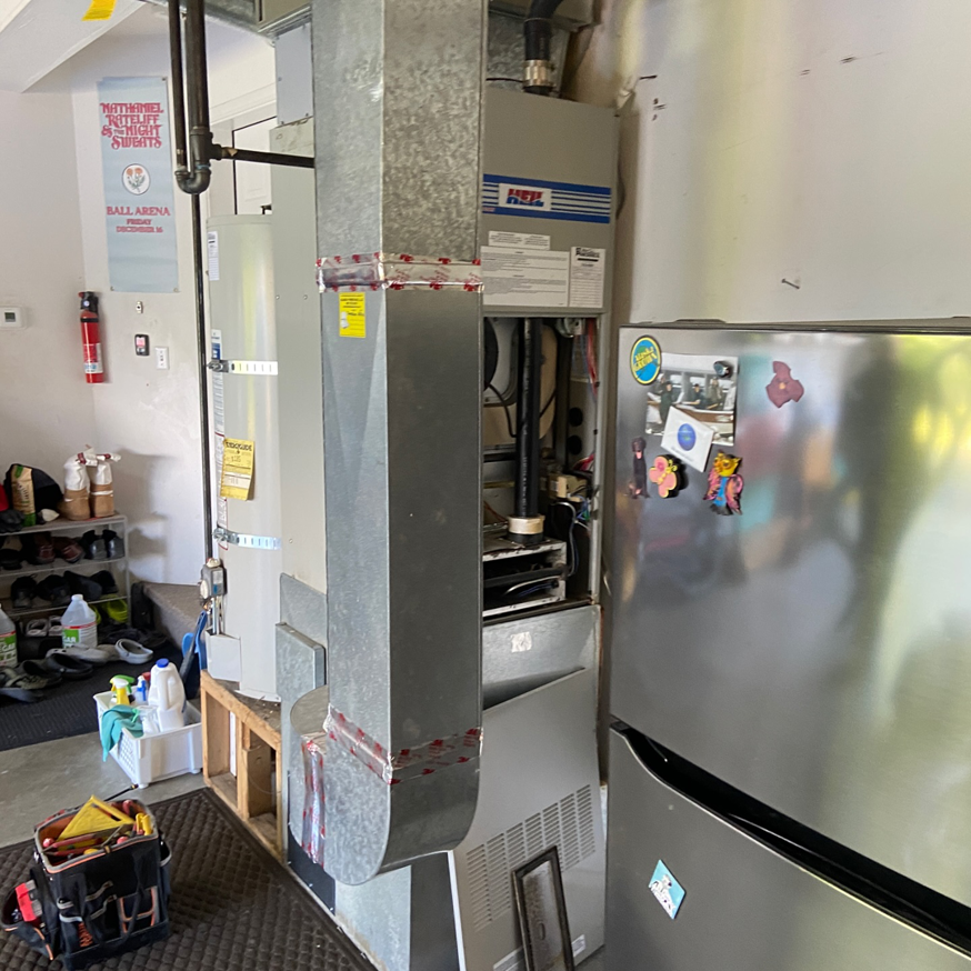 An HVAC technician's toolbox next to a furnace being serviced or repaired by Arctic Heating And Cooling in Chesapeake, VA.