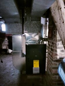 An HVAC furnace system with ductwork installed in a basement by Bean'z Heating and Cooling in Chicago, IL.