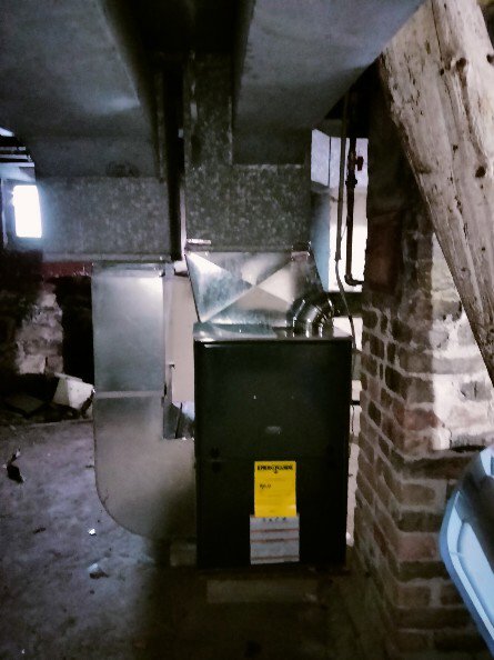 An HVAC furnace system with ductwork installed in a basement by Bean'z Heating and Cooling in Chicago, IL.