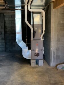 A new HVAC furnace system installation with ductwork in a basement by Pacifico Heating and Cooling in Shadyside, OH.