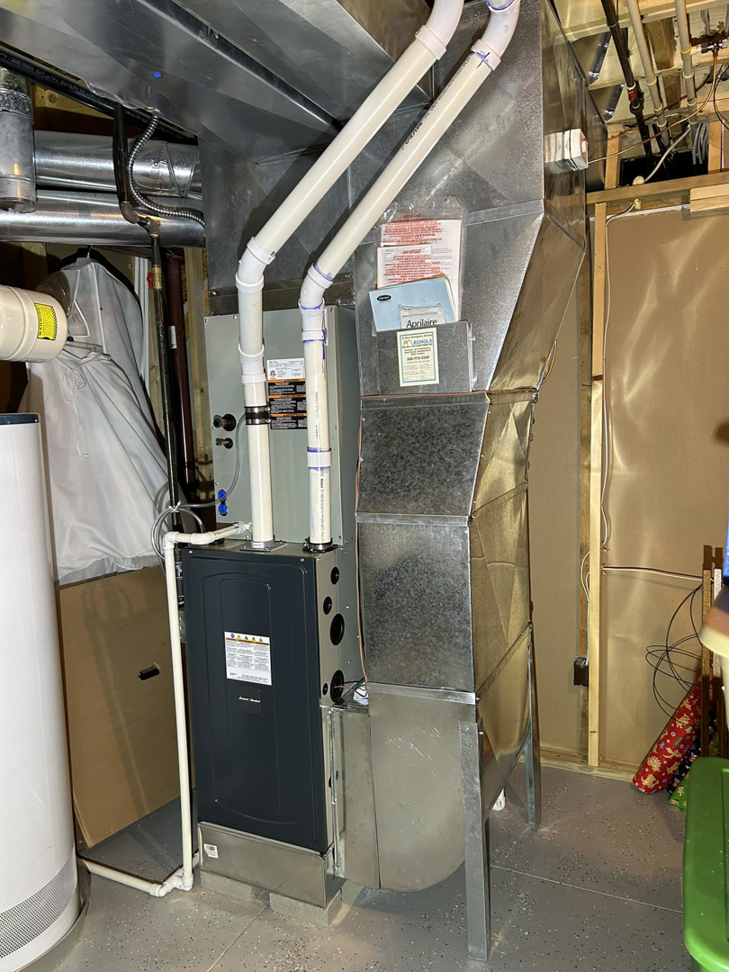 A complete HVAC furnace system with ductwork and piping installed by Handy Properties LLC in Akron, OH.