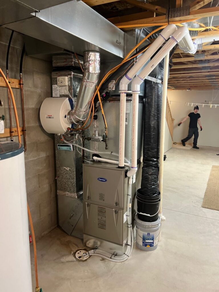 A complete HVAC furnace and water heater system installed in a basement by Bloomington Heating & Air in Bloomington, MN.