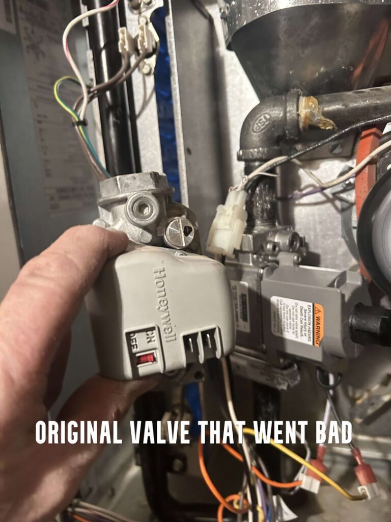 A technician holding a faulty Honeywell gas valve during a replacement by 32 Degrees Heating and Air Conditioning in Las Vegas, NV