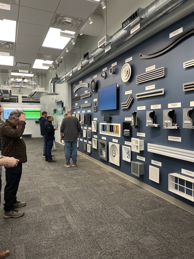 A display of various HVAC grilles, diffusers, and vents at Buckley Associates, Inc. in Hanover, MA