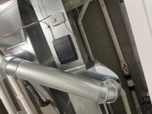 Control wiring and an Aprilaire humidifier connected to HVAC ductwork by Trade Allies Heating and Cooling in Ankeny, IA.