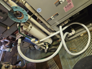 An indoor HVAC unit undergoing maintenance or installation by Acclimated Air LLC in Virginia Beach, VA.