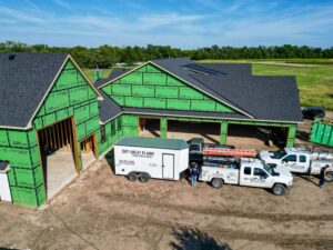Great Plains Heating & Air trucks and trailer at a new construction site for HVAC installation in Goddard, KS.
