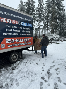 Two technicians from Best Heat & Air delivering a new HVAC unit for installation in Tacoma, WA.