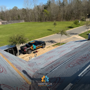 North LA Heating and Cooling truck and trailer at a construction site for HVAC installation in Monroe, LA.