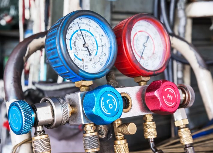 Close-up of HVAC manifold gauges used for refrigerant service by The Right Flow Heating and Air LLC in Lawton, OK