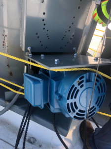 Close-up of a blue HVAC motor with drive belts being serviced by L.N.P Heating & Cooling in Columbus, OH