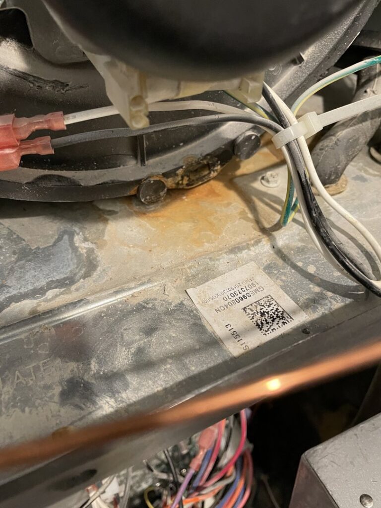 Close-up view of an HVAC unit motor showing signs of corrosion during an inspection by LUCAS Heating And Air LLC in Salt Lake City, UT.