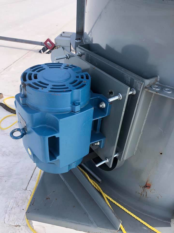 A blue motor being installed on a large rooftop HVAC unit by L.N.P Heating & Cooling in Columbus, OH
