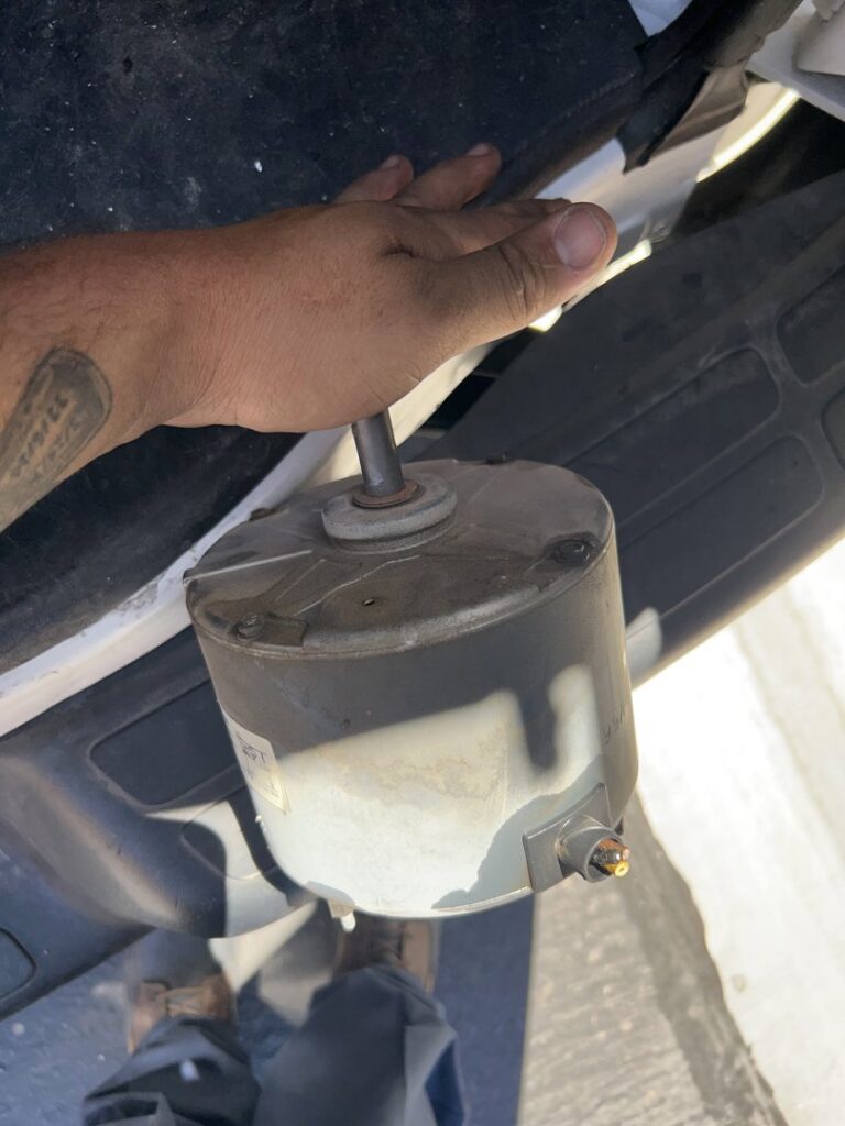 A hand holding an HVAC motor, likely for replacement or inspection, by Sahara Air Conditioning & Heating in Las Vegas, NV