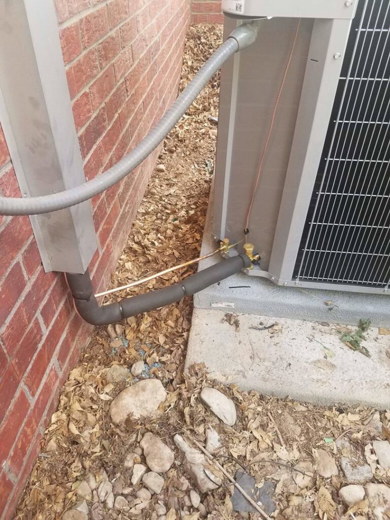 Refrigerant lines and electrical connections on an outdoor HVAC unit by Anderson Refrigeration, Inc. in Poplar Grove, IL.