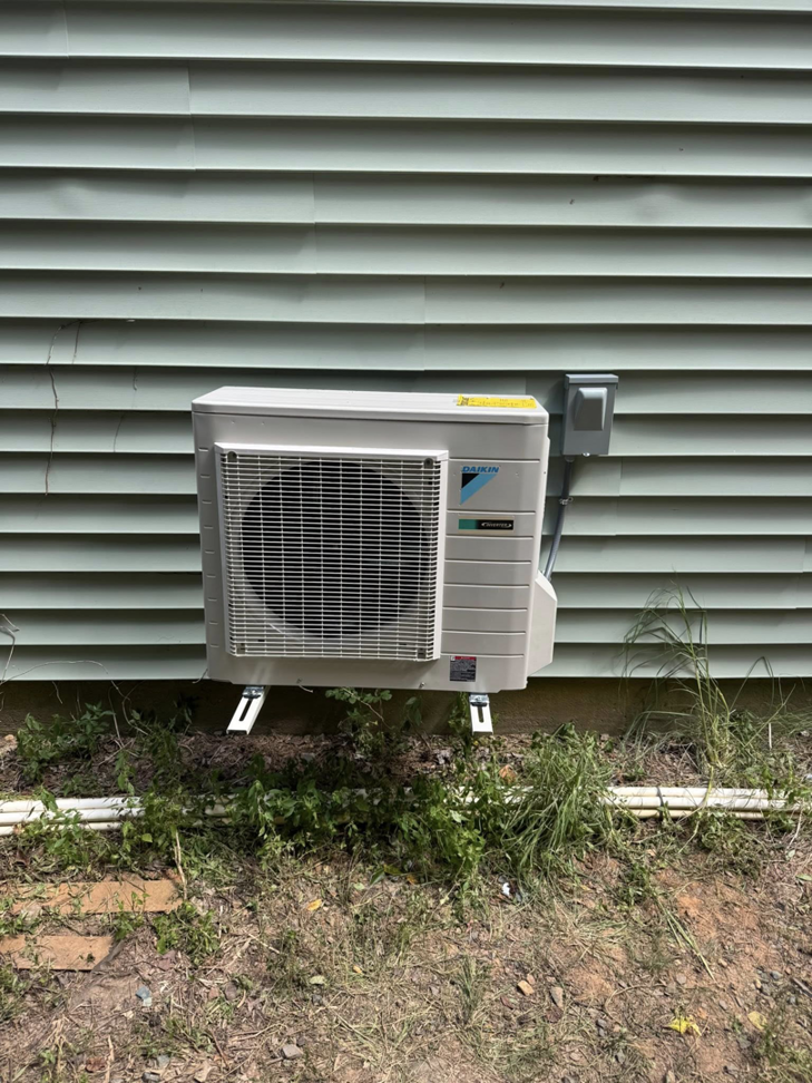 An HVAC outdoor unit with electrical connection completed by DD HVAC PROS in Charlotte, NC.