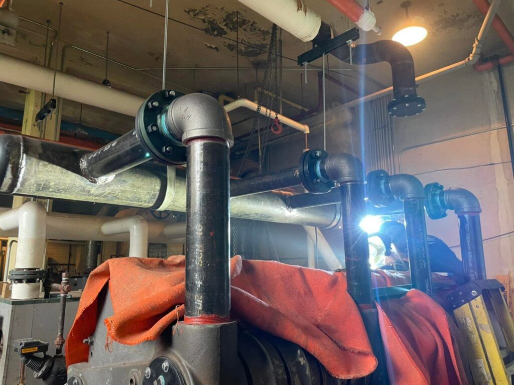 HVAC piping installation in progress by Detroit Metro Mechanical, Inc. in Harrison Township, MI.