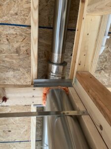 HVAC piping and ductwork being installed through wall studs by Steve's Heating & Cooling in Florence, KY.