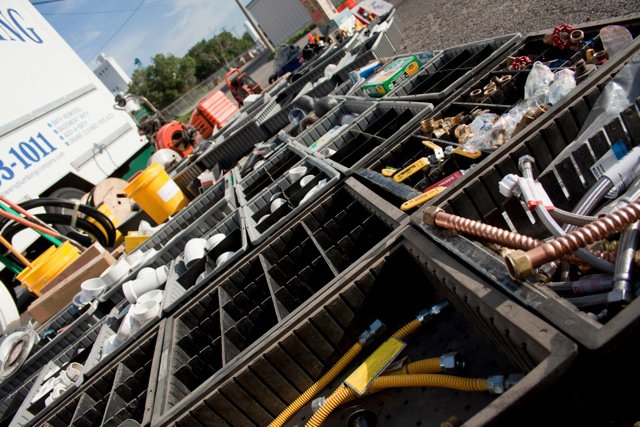 Bins of HVAC and plumbing parts, including gas lines, ready for service by Bowers Heating and Air Conditioning in Wichita, KS