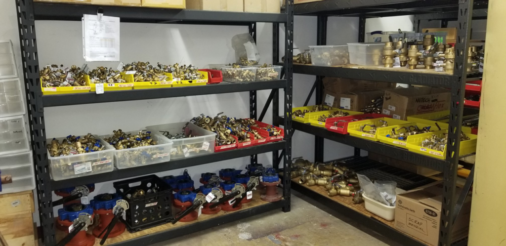 Shelves stocked with various HVAC and plumbing parts and fittings at Kevin McGovern Associates, Inc. in Columbus, OH.