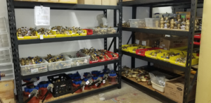 Shelves stocked with various HVAC and plumbing parts and fittings at Kevin McGovern Associates, Inc. in Columbus, OH.