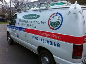 A branded service van for Environmental Heating & Air NC, featuring HVAC and plumbing services, seen in Cary, NC.