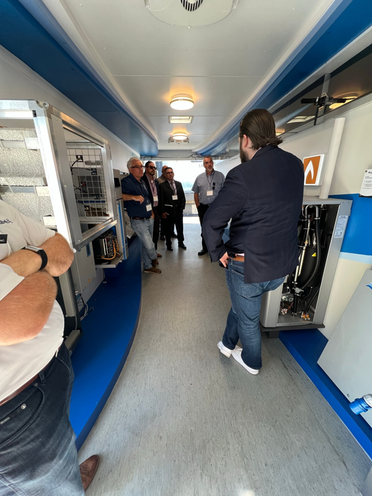 HVAC professionals training on Condair equipment inside a mobile trailer, showcasing services by Stillwell-Hansen Inc. in Edison, NJ.
