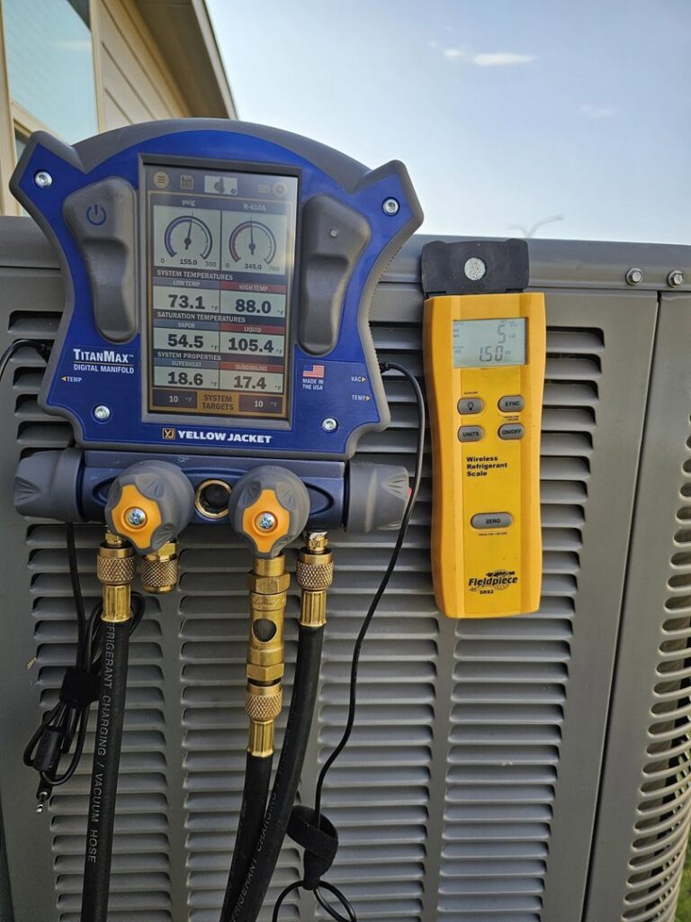 Digital manifold gauge and wireless refrigerant scale connected to an outdoor AC unit for service by MasterCraft Mechanical, LLC. in Haslet, TX.