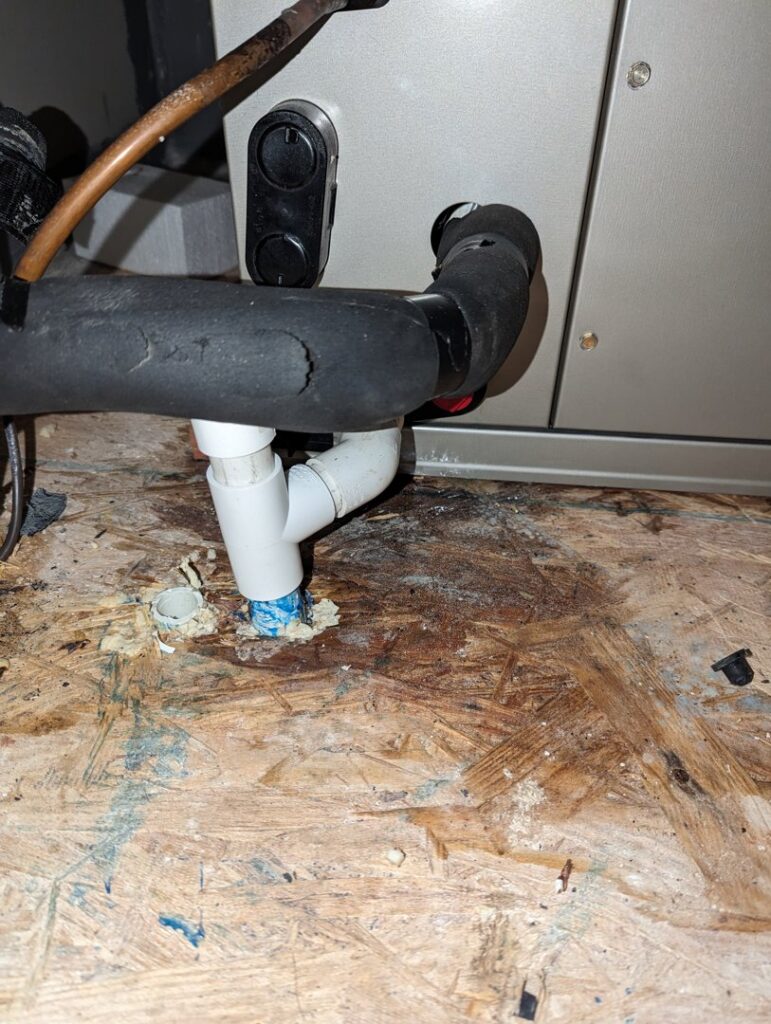 Close-up of HVAC refrigerant and condensate drain lines installed by Zippers Heating and Cooling in Mobile, AL.