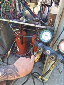 HVAC refrigerant gauges connected to an AC unit during a service by Recovery HVAC in Smyrna, TN.