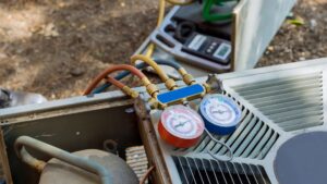 Refrigerant gauges connected to an outdoor AC unit during a service call by Arizaz Heating & Cooling in Chandler, AZ.
