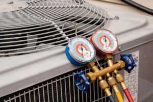 Refrigerant gauges connected to an outdoor air conditioning unit during service by Wyles Heating & Air Conditioning Inc. in North Canton, OH.