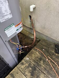 Copper refrigerant lines being connected to an outdoor HVAC unit during installation or repair by Southern Climate Pros in Jasper, AL.