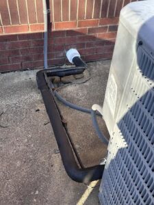 Insulated HVAC refrigerant lines and electrical conduit connected to an outdoor AC unit by Oakes AC Services, LLC in Louisburg, NC