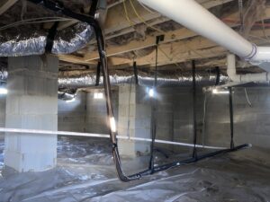 New HVAC refrigerant lines and ductwork installed in a residential crawl space by Oakes AC Services, LLC in Louisburg, NC