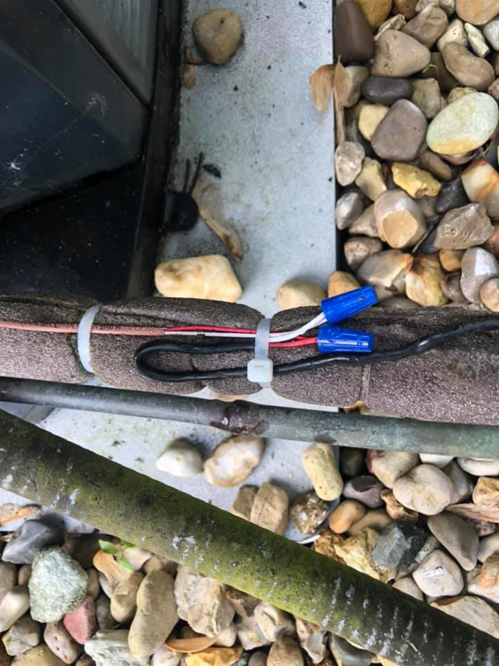 Close-up of insulated refrigerant lines and electrical wiring for an HVAC unit by Fellowship Heating and Cooling in Indianapolis, IN.